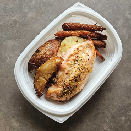 Chicken breast stuffed with ham and cheese served with roasted potatoes and vegetables